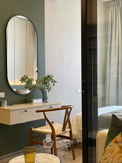 Stylish bedroom with modern decor, featuring a chic mirror, elegant chair, and cozy bed setup.