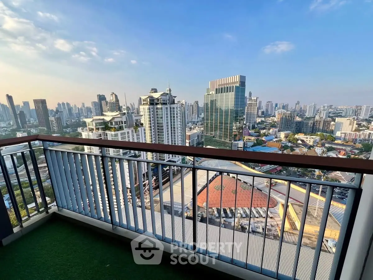 Stunning cityscape view from a high-rise balcony with modern railing.