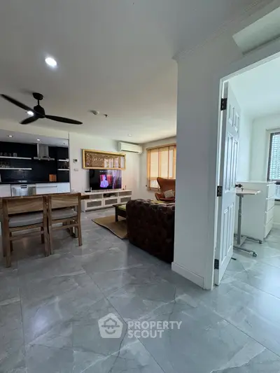 Spacious open-plan living room with modern kitchen and stylish decor