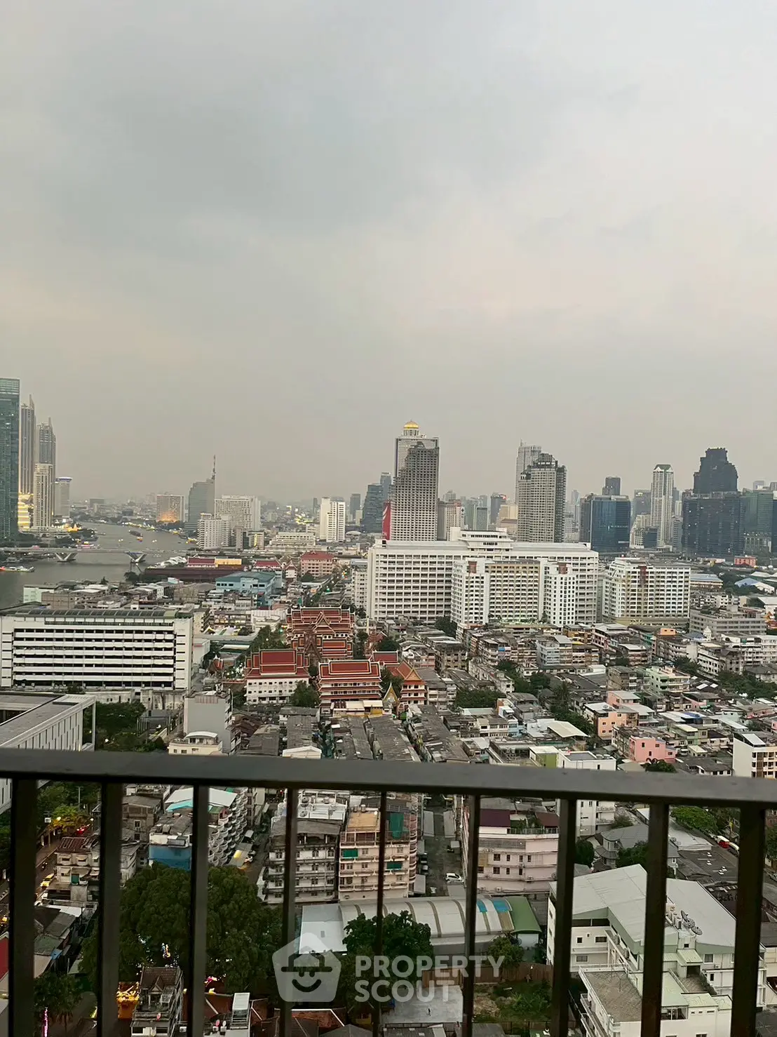 Stunning cityscape view from a high-rise balcony overlooking the urban skyline.