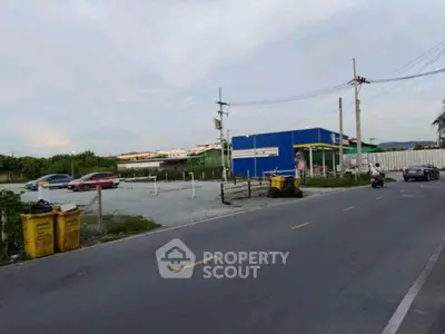 Spacious parking area with road access and surrounding greenery