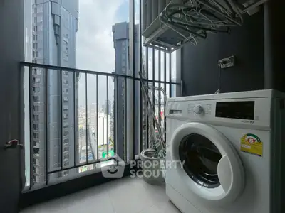 High-rise balcony with washing machine and cityscape view, perfect for urban living.