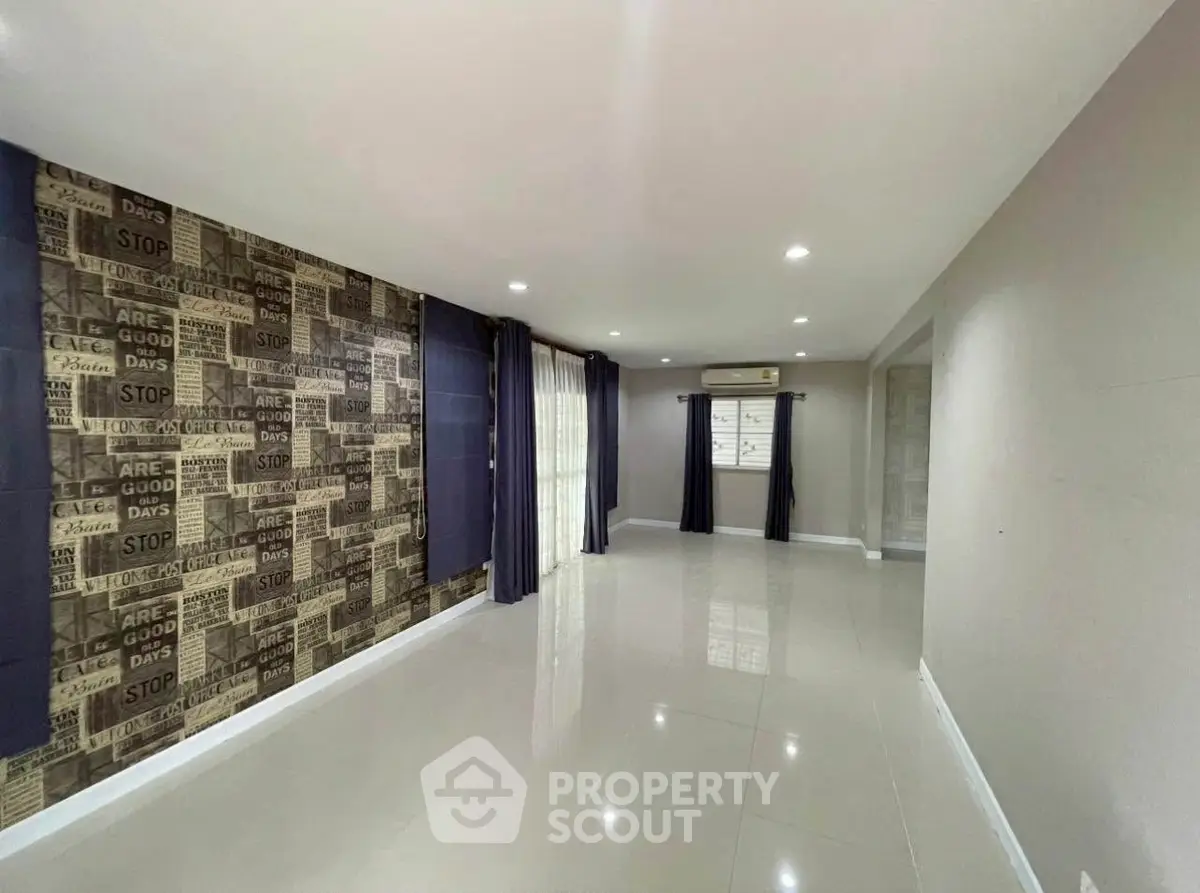 Spacious living room with modern decor and large windows for natural light.