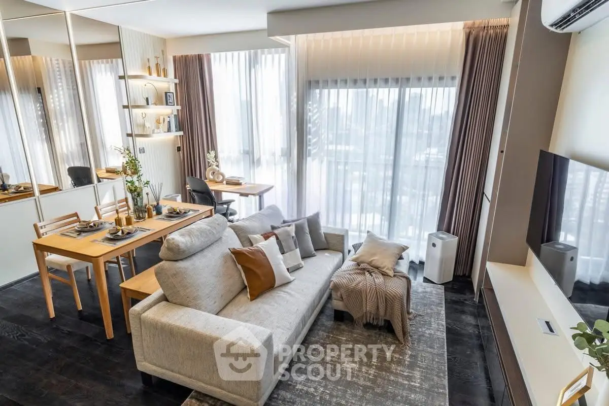 Modern living room with stylish decor and large windows offering natural light