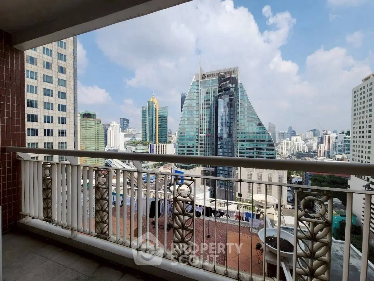 Stunning cityscape view from a spacious balcony in a high-rise building.