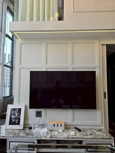Luxurious living room with modern TV setup and elegant decor