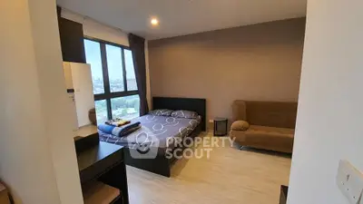 Modern bedroom with city view, featuring cozy bed and stylish decor