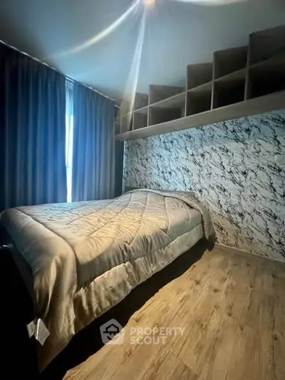 Cozy bedroom with modern decor and stylish wall design, perfect for relaxation.