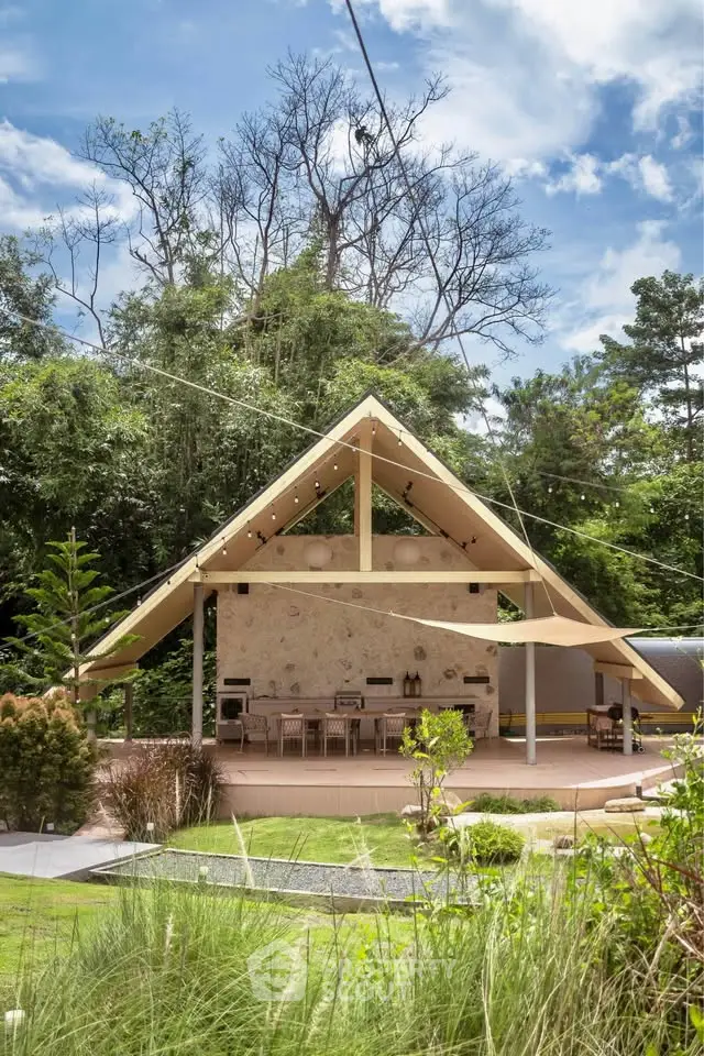 Stunning modern outdoor pavilion with lush greenery and open-air dining area, perfect for entertaining.