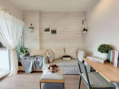 Charming living room with cozy decor and natural light, perfect for relaxation and entertaining.