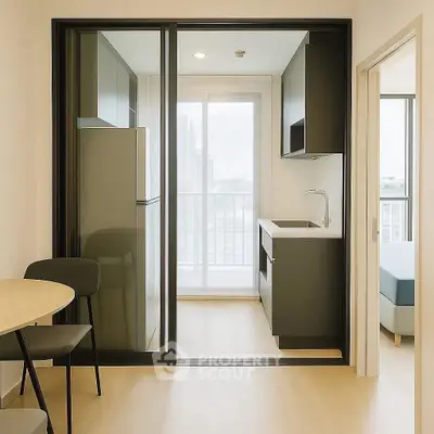 Modern compact kitchen with sliding glass doors and city view balcony.