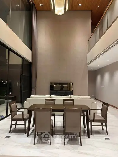 Luxurious modern living room with high ceilings and elegant dining area, perfect for sophisticated gatherings.