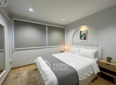 Cozy modern bedroom with stylish decor and natural light