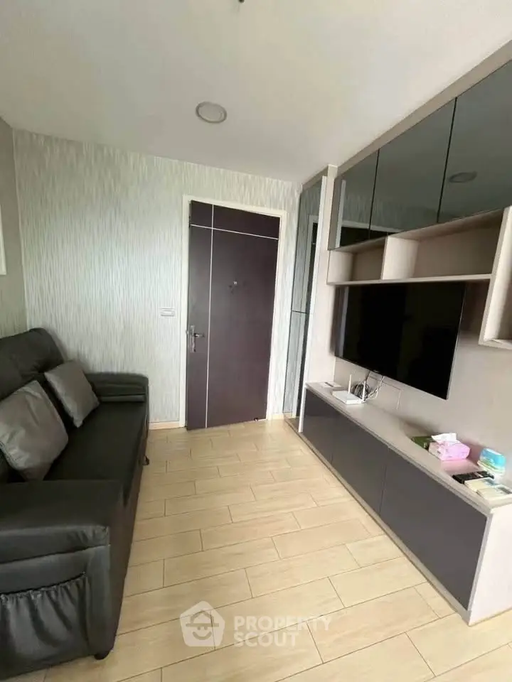 Modern living room with sleek furniture and built-in TV unit, perfect for cozy urban living.