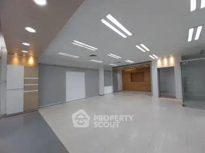 Spacious modern office space with sleek lighting and open layout