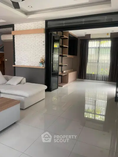 Spacious modern living room with sleek design and large windows for natural light.