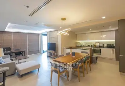 Spacious modern living room with open kitchen and stylish lighting