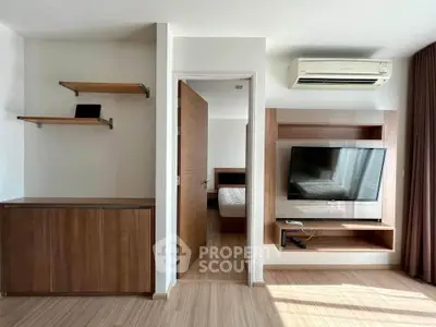 Modern living room with wooden furniture and wall-mounted TV in a stylish apartment.