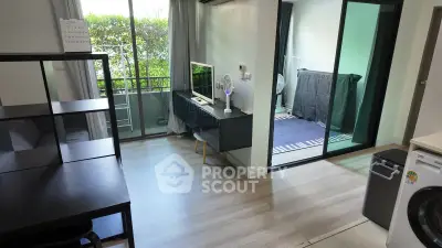 Modern apartment interior with balcony and washing machine, featuring sleek design and natural light.