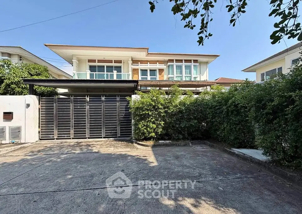 Spacious modern house with lush greenery and ample parking space in a serene neighborhood.