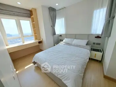 Bright and airy bedroom with modern furnishings and large windows offering a stunning view.