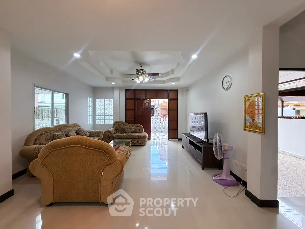 Spacious living room with elegant furniture and modern ceiling fan