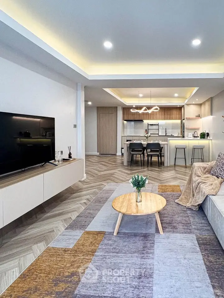 Modern open-plan living room with stylish kitchen and cozy decor