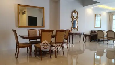 Elegant dining area with classic wooden furniture and large mirrors in a spacious living room.