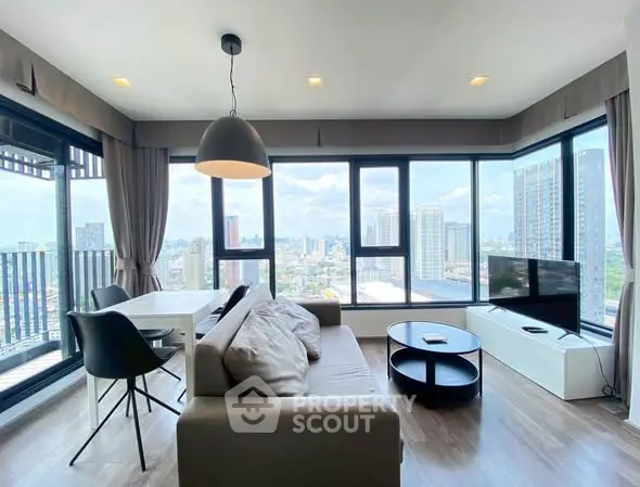 Spacious modern living room with panoramic city views and stylish furnishings.