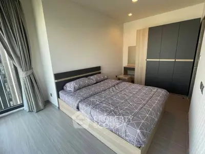 Modern bedroom with stylish decor and large window for natural light