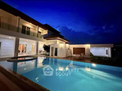 Luxurious modern villa with stunning pool and elegant night lighting