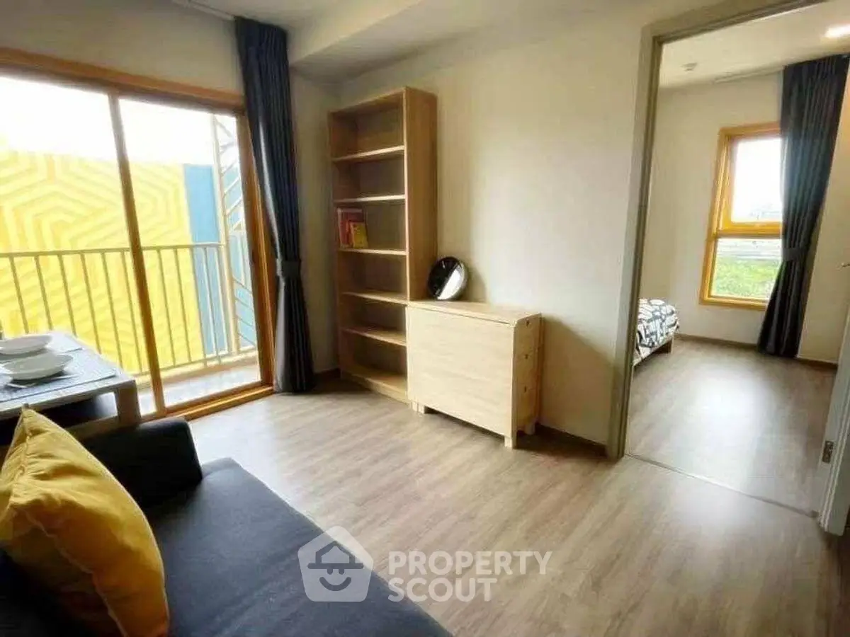 Modern apartment with open living area and balcony access