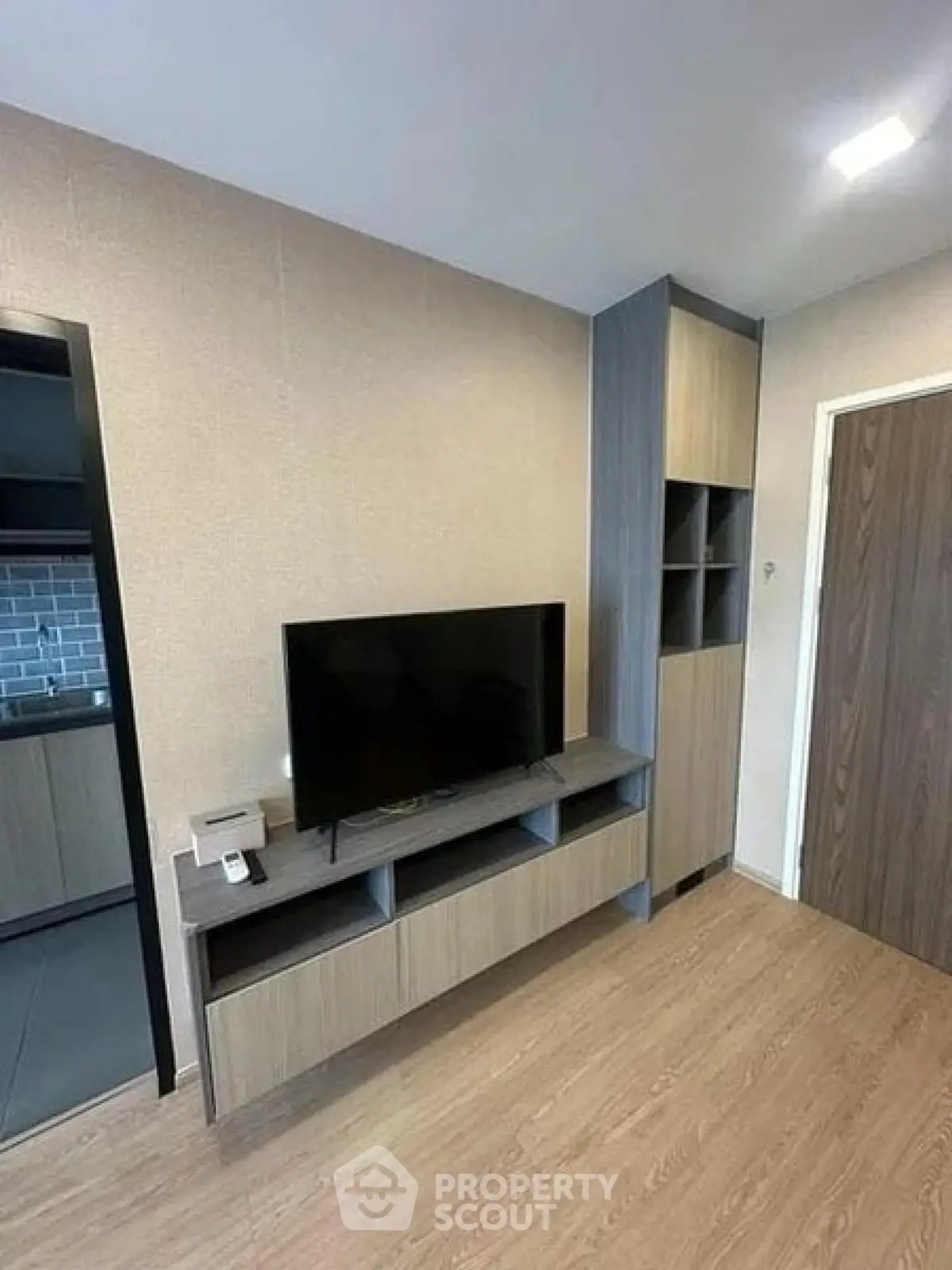 Modern living room with sleek TV stand and wooden flooring