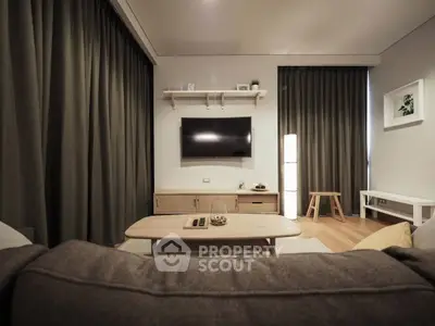 Modern living room with sleek furniture and wall-mounted TV, perfect for relaxation.