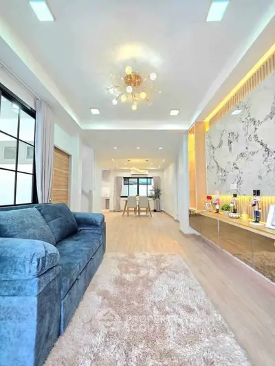 Spacious modern living room with elegant decor and plush blue sofa