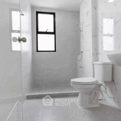 Modern minimalist bathroom with sleek fixtures and elegant marble accents.