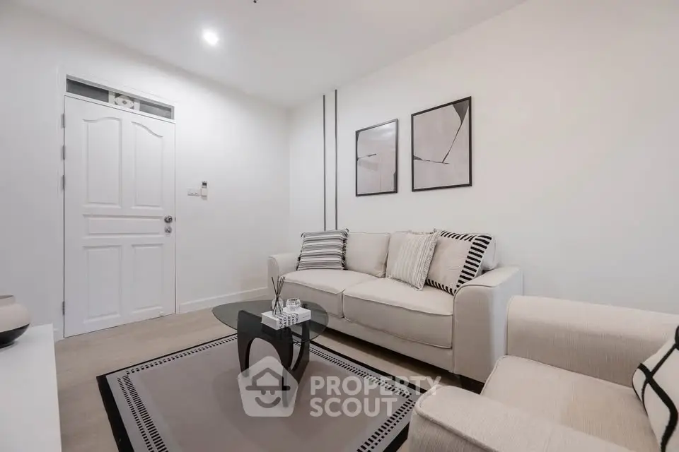Modern living room with stylish decor and cozy seating in a contemporary apartment.