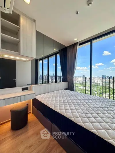 Modern bedroom with floor-to-ceiling windows offering stunning city views and natural light.