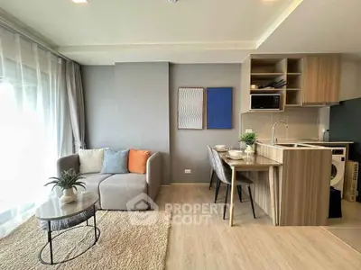 Modern living room with open kitchen, cozy sofa, and stylish decor