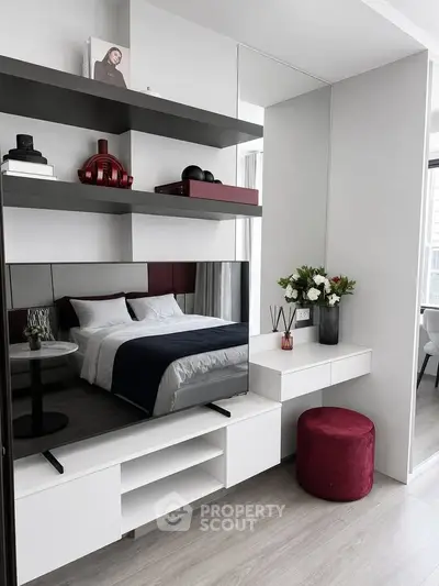 Modern bedroom with sleek design, featuring built-in shelves, a cozy bed, and elegant decor accents.