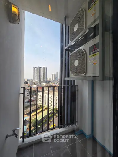 Modern balcony with city view and air conditioning units, perfect for urban living.