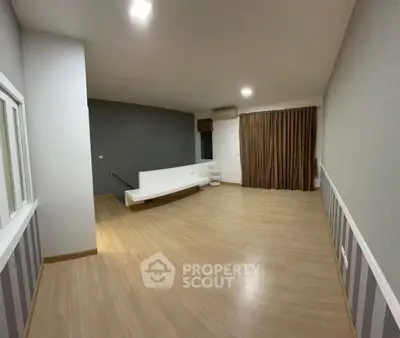 Spacious modern living room with wooden flooring and minimalist design