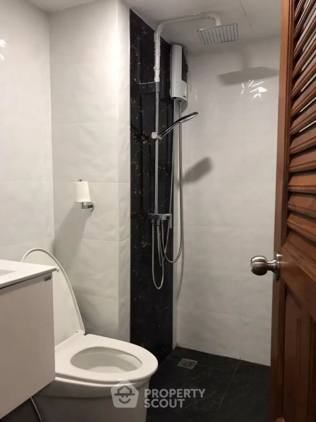 Modern bathroom with sleek shower and toilet in compact space