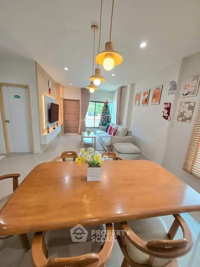 Spacious living room with elegant dining area and festive decor