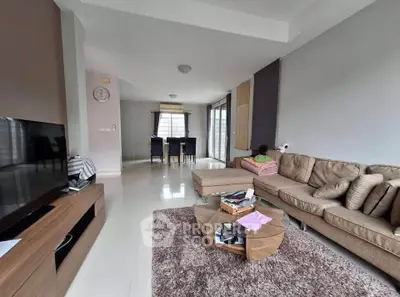 Spacious modern living room with cozy sectional sofa and dining area