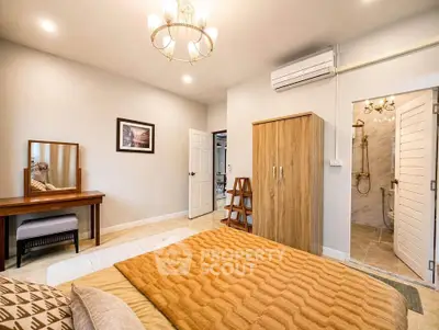 Spacious bedroom with elegant decor and ensuite bathroom in modern apartment