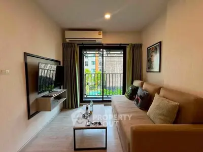 Modern living room with balcony view, stylish decor, and cozy seating in a contemporary apartment.