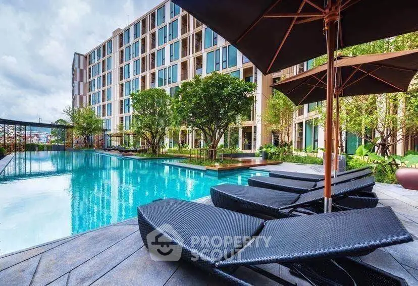 Luxurious apartment complex with stunning poolside view and modern amenities.