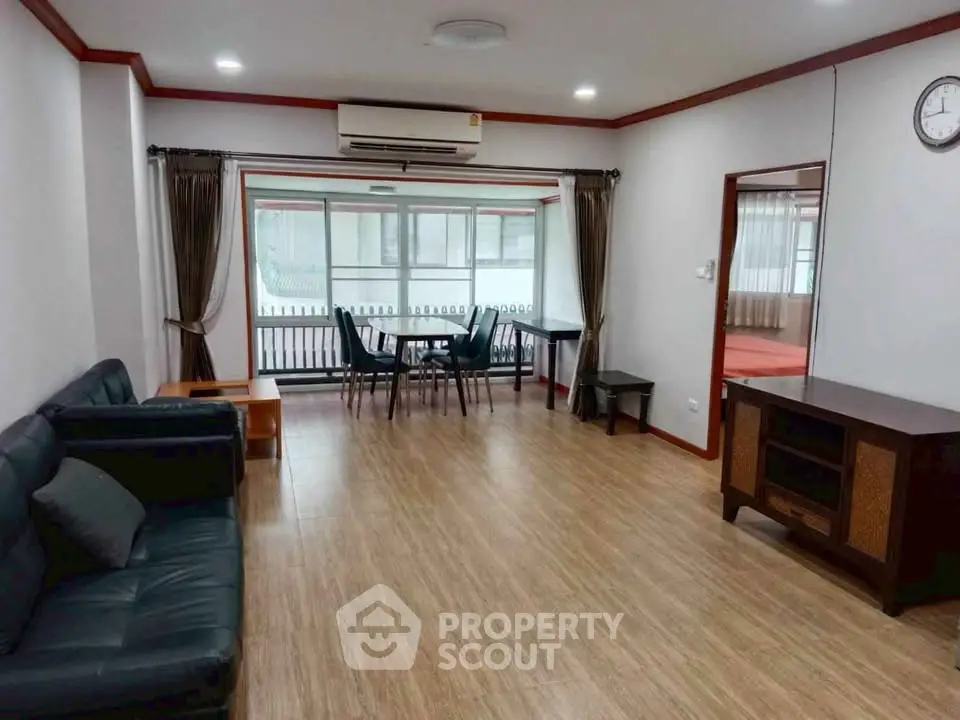 Spacious living room with modern furniture and large windows for natural light.