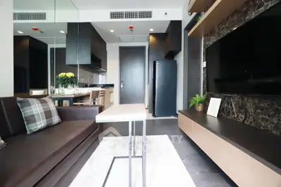 Modern living room with sleek furniture and open kitchen layout